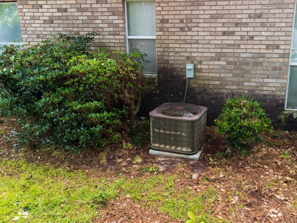 HVAC System Outside of House next to Bushes