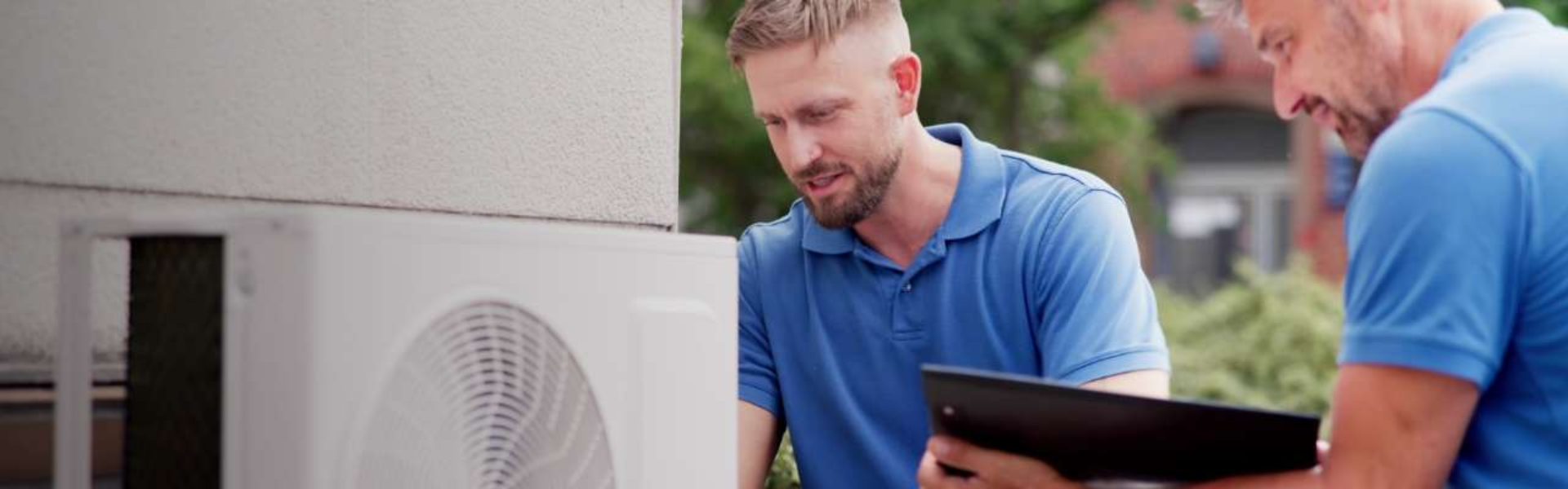 Technician servicing Cape Cod heating and air conditioning system for residential HVAC maintenance and energy efficiency